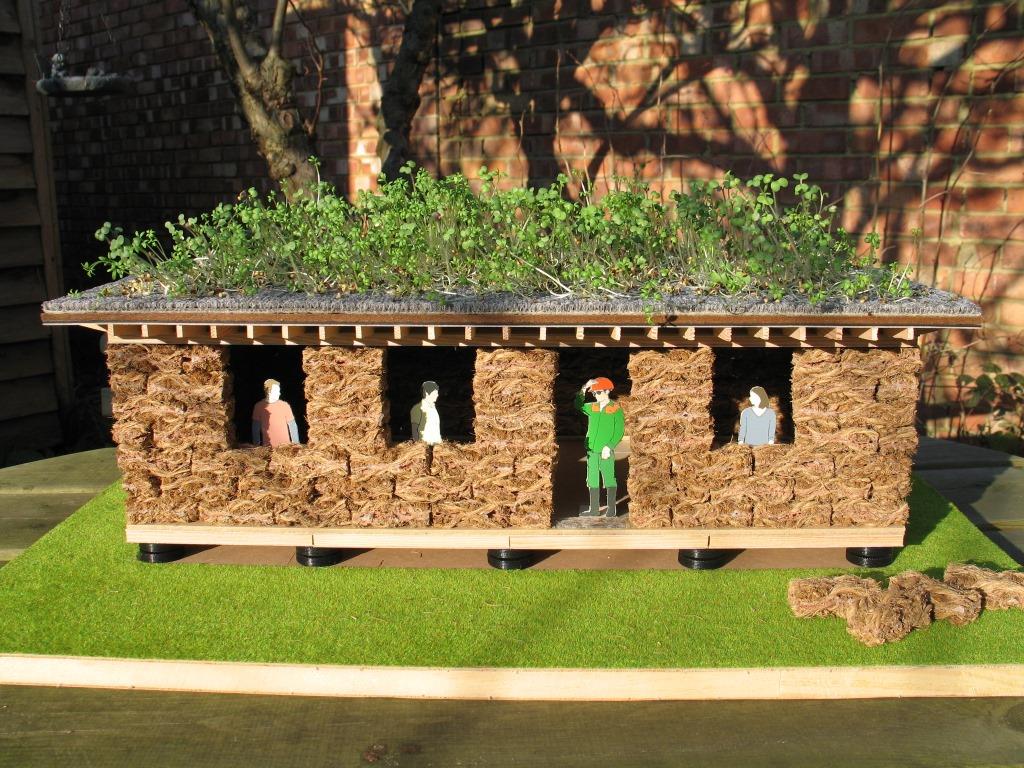 Prototype &apos;straw-bale, car-tyre &amp; green-roof&apos; low-tech building. Teaching model used for school workshops on building with natural and recycled materials.